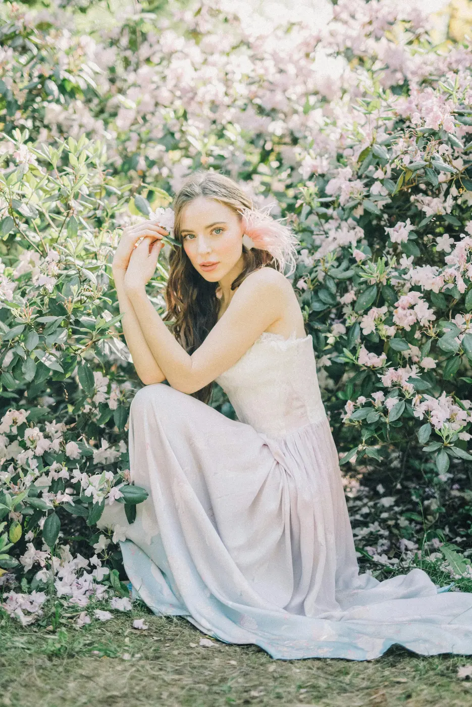 Young woman wearing a formal gown among blossom